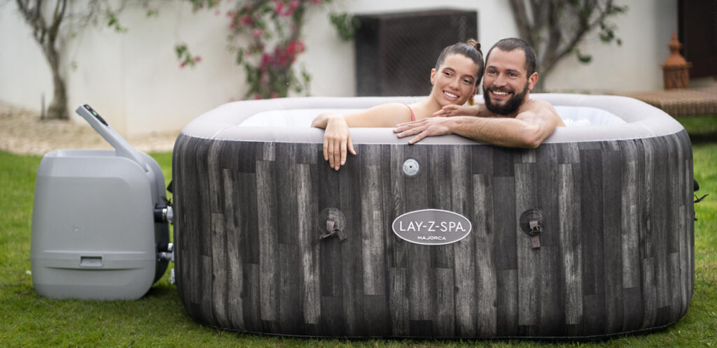 Couple relaxing in an inflatable hot tub